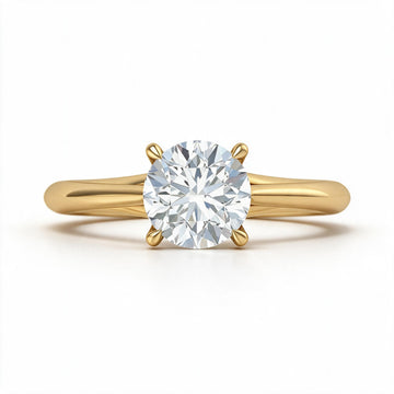 A classic yellow gold solitaire engagement ring featuring a round brilliant-cut diamond center stone in a four-prong setting, shown on a clean white background.