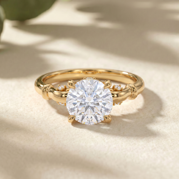A gold ring with a large round brilliant-cut clear center stone and small side stones, photographed on a soft beige surface with natural-looking shadows.