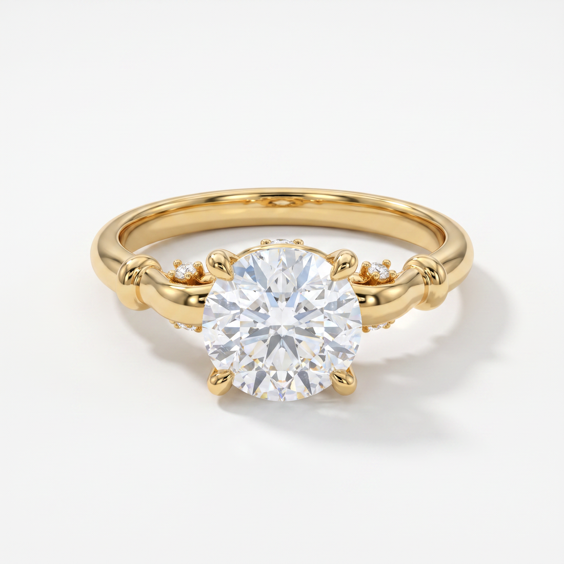 A yellow gold solitaire engagement ring with a round brilliant-cut center stone and small accent diamonds on the band, set against a clean white background.