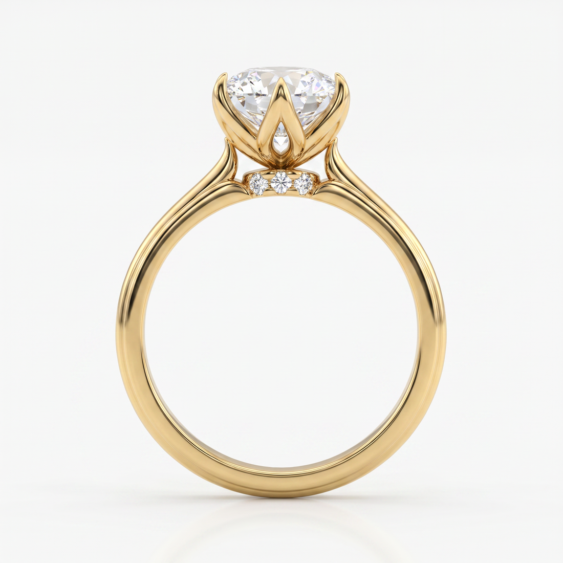 A yellow gold ring with a large round-cut diamond center stone and two small accent diamonds, shown on a clean white background.